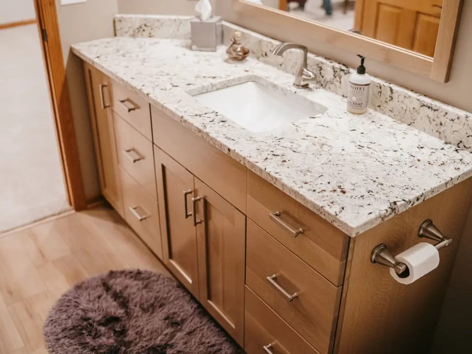 Custom oak vanity with granite countertop bathroom by North Haven Design Build